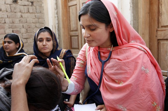 A female doctor with the International Medical Corps examines a