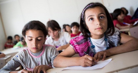 CROP-Iraq-May-2013.-Ten-year-old-Syrian-refugee-Ahin-right-following-the-lesson-among-other-pupils-in-the-KAR-school-in-the-Domiz-refugee-camp-in-Northern-Iraq.-©-UNICEF-UKLA2012-00993-KARIN-SCHERMBRUCKER-745x400